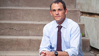 Portrait of President Ryan sitting outside on Grounds