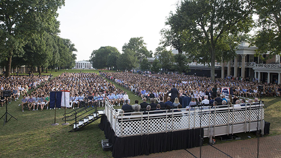 The Lawn full of graduate while a stage is full of UVA leadership